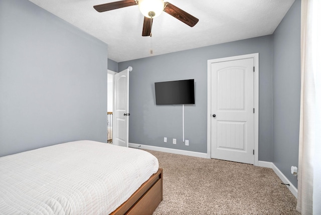 bedroom featuring ceiling fan and carpet