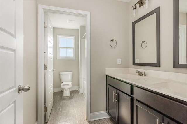 full bathroom with shower / bath combination, vanity, and toilet