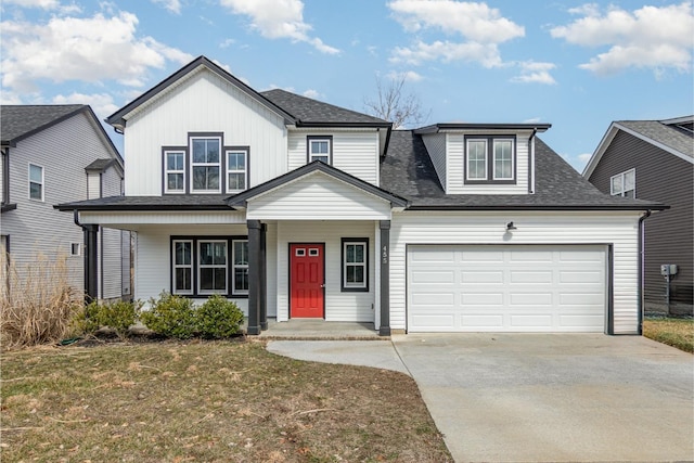 view of front of home with covered porch, a front lawn, and a garage