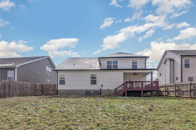 back of property with ceiling fan, a wooden deck, cooling unit, and a lawn