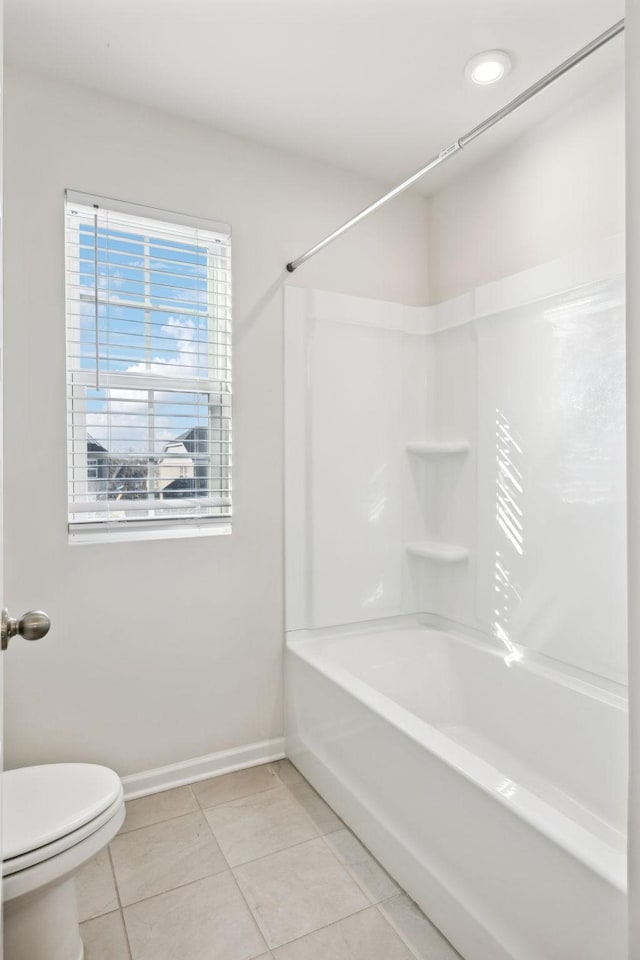 bathroom featuring toilet, tile patterned flooring, and shower / bathtub combination