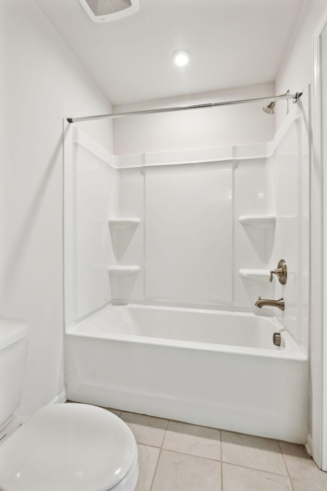 bathroom featuring toilet, tile patterned flooring, and shower / bathtub combination