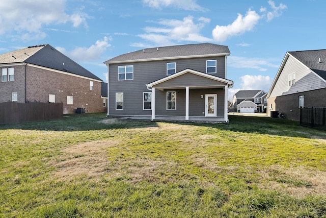 rear view of house with a yard and central AC unit