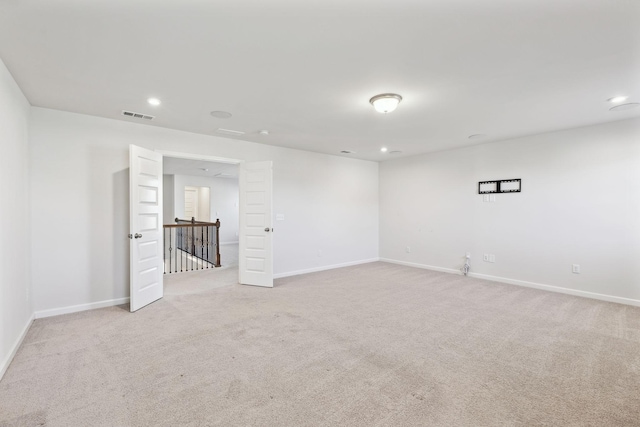 unfurnished room with light carpet