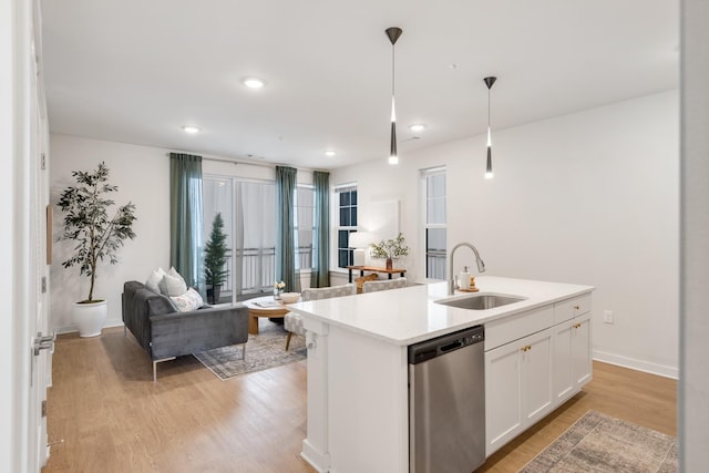 kitchen with sink, white cabinetry, dishwasher, an island with sink, and pendant lighting