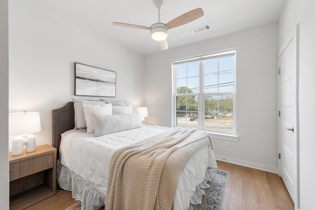 bedroom with ceiling fan and light hardwood / wood-style flooring