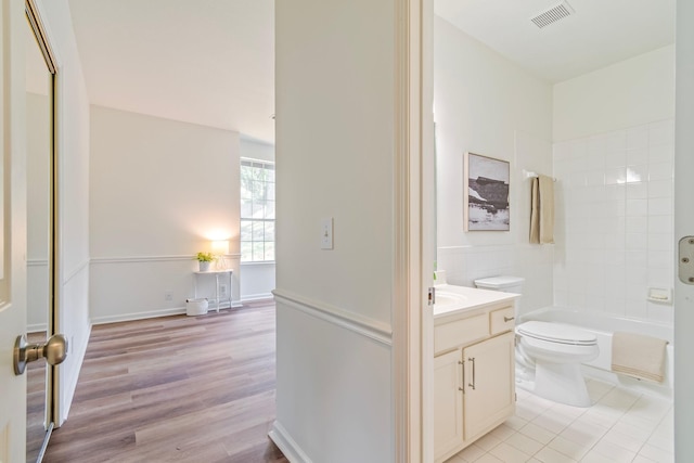 full bathroom with bathing tub / shower combination, tile patterned floors, vanity, and toilet