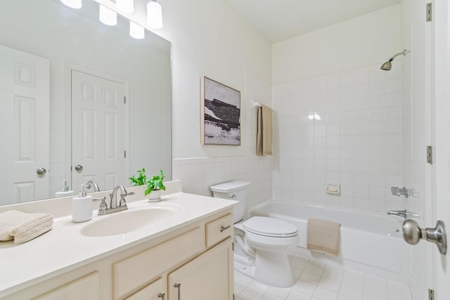 full bathroom with tiled shower / bath, tile walls, toilet, tile patterned floors, and vanity