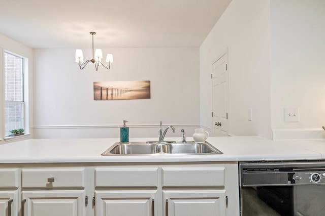 kitchen featuring sink, white cabinetry, a chandelier, and dishwasher