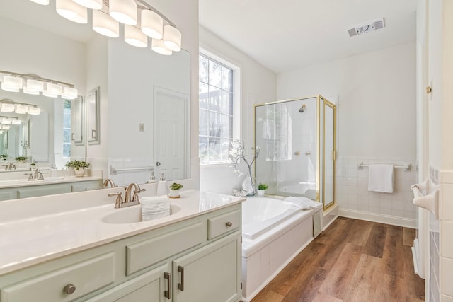 bathroom featuring hardwood / wood-style flooring, separate shower and tub, and vanity