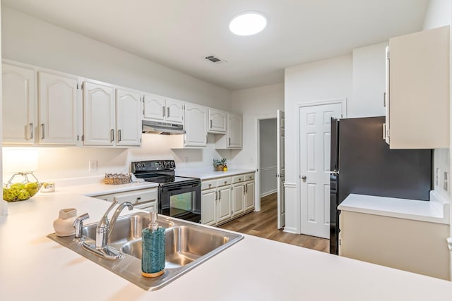 kitchen featuring sink, white cabinetry, black appliances, and dark wood-type flooring