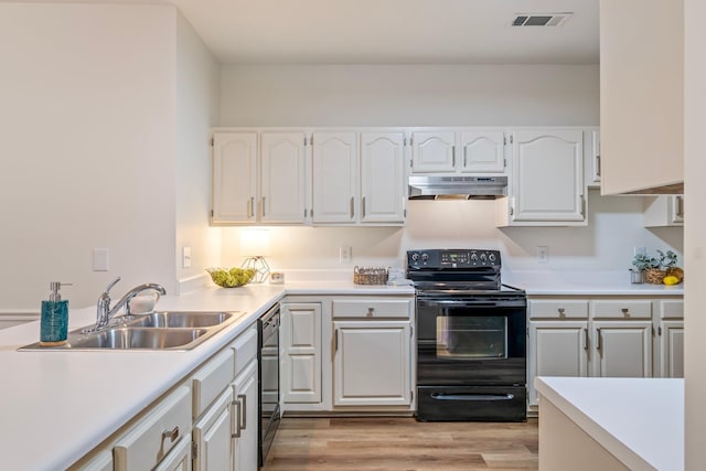 kitchen with sink, light hardwood / wood-style floors, white cabinets, and black appliances