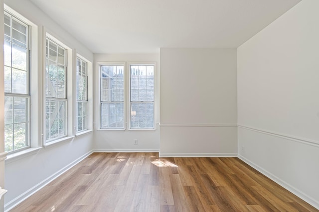 unfurnished room with wood-type flooring