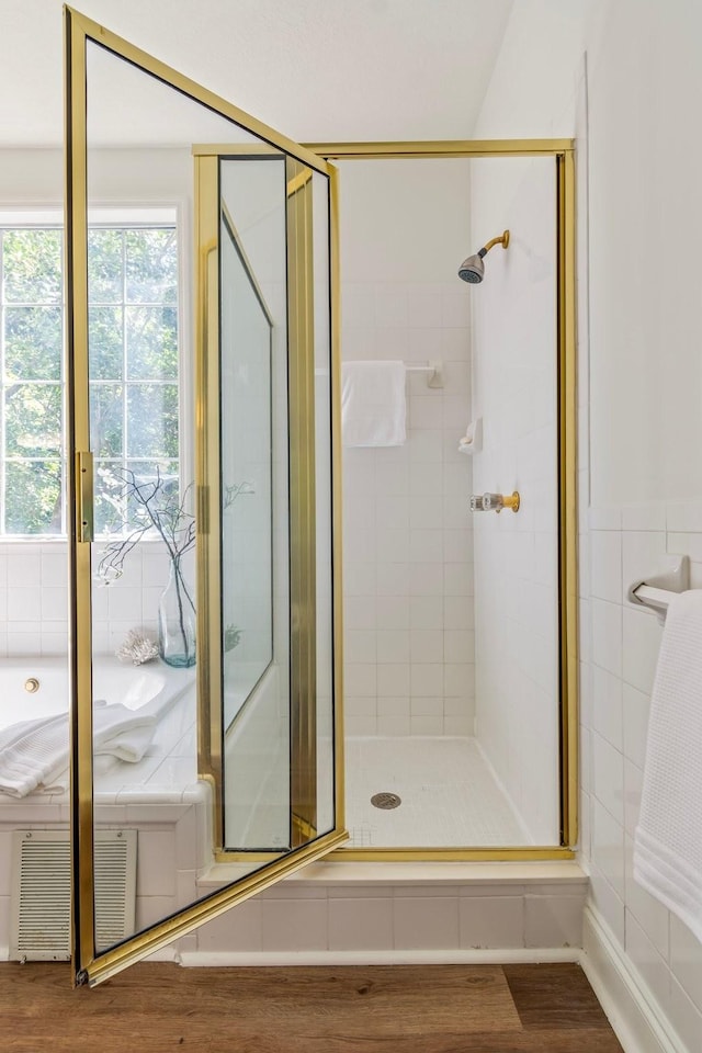 bathroom with walk in shower and hardwood / wood-style floors