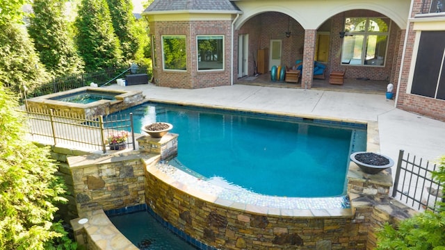 view of pool with a patio and an in ground hot tub