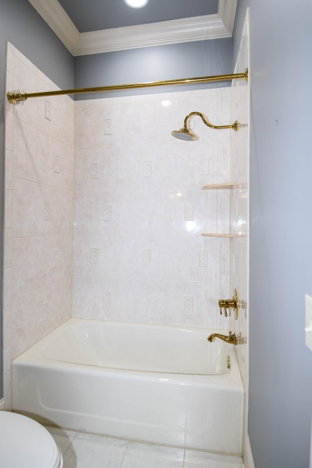 bathroom with crown molding, tile patterned flooring, toilet, and tiled shower / bath