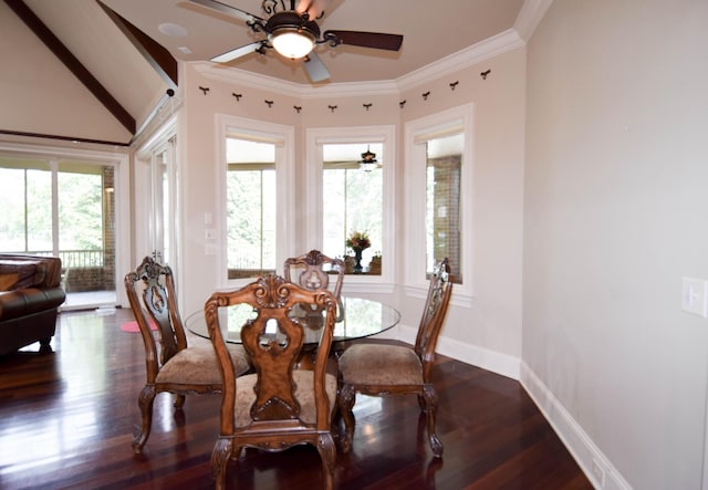 dining area with dark wood-type flooring, lofted ceiling, plenty of natural light, and crown molding