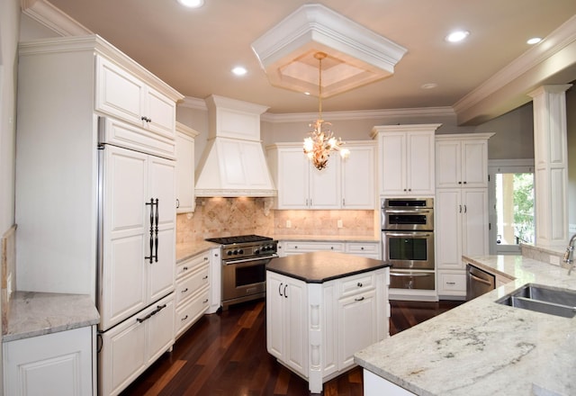 kitchen with sink, decorative light fixtures, high end appliances, custom exhaust hood, and decorative backsplash