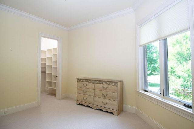 bedroom with a walk in closet, a closet, and crown molding