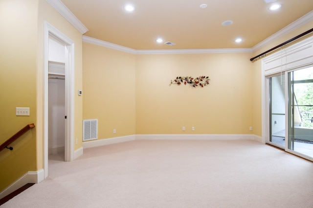 carpeted spare room featuring crown molding