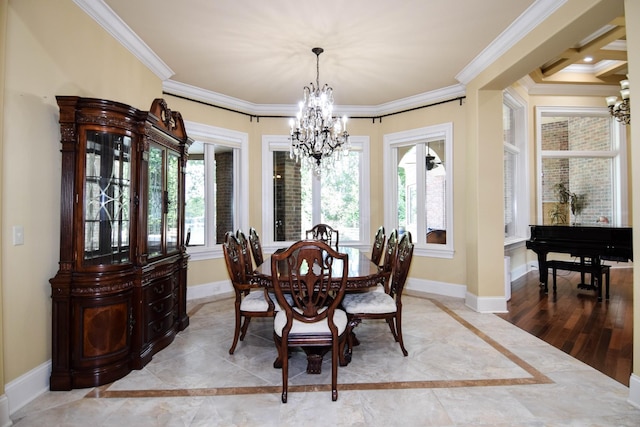 dining area with crown molding and a chandelier