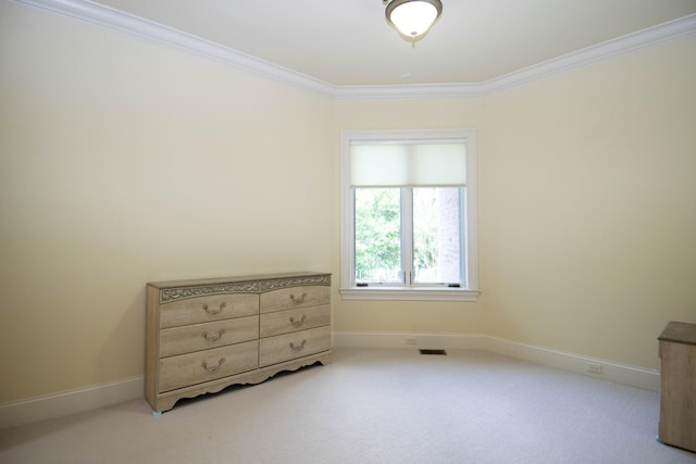 bedroom with ornamental molding and light carpet