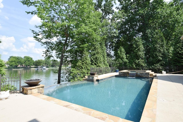 view of pool with an in ground hot tub and a water view