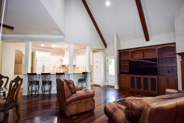 living room with decorative columns, high vaulted ceiling, beamed ceiling, and dark hardwood / wood-style floors