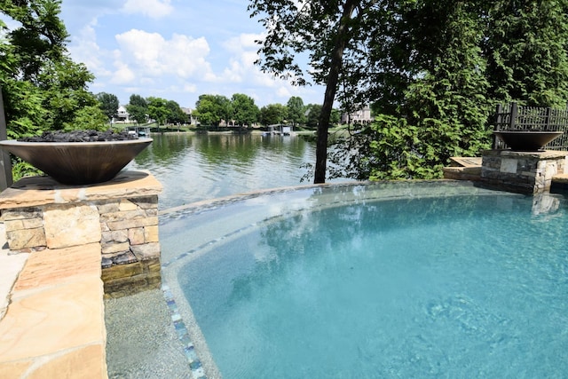 view of swimming pool featuring a water view