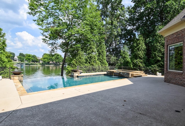 view of swimming pool featuring a patio area, an in ground hot tub, and a water view