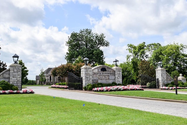 community sign featuring a lawn