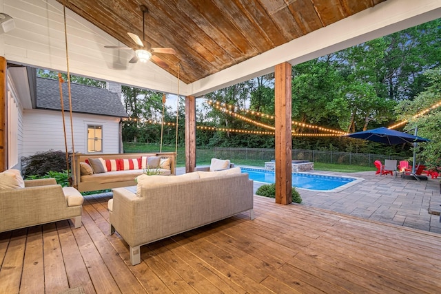 exterior space featuring a fenced in pool, ceiling fan, and outdoor lounge area