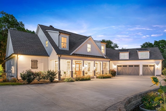 view of front of property with a porch and a garage