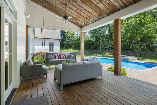 wooden deck featuring ceiling fan, a swimming pool with hot tub, and outdoor lounge area