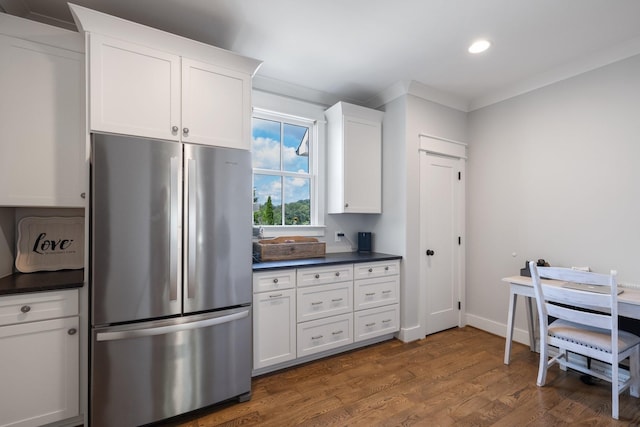 kitchen with stainless steel refrigerator, dark hardwood / wood-style floors, and white cabinetry