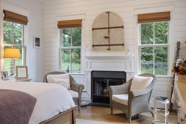 bedroom featuring light hardwood / wood-style floors and wooden walls