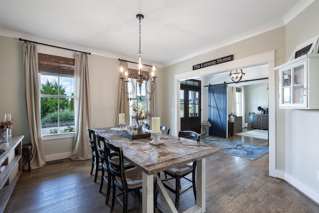 dining room with dark hardwood / wood-style flooring, an inviting chandelier, crown molding, and a barn door