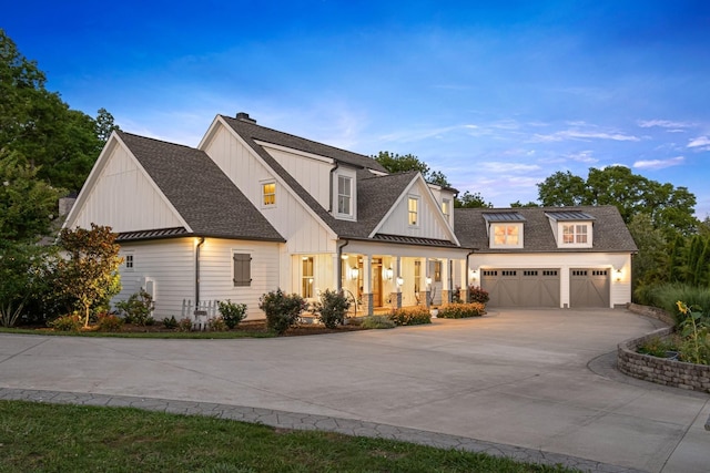 modern inspired farmhouse featuring a porch and a garage