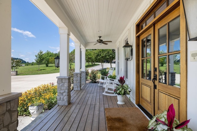 wooden deck with ceiling fan and a porch