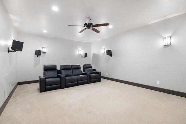 carpeted cinema room with ceiling fan