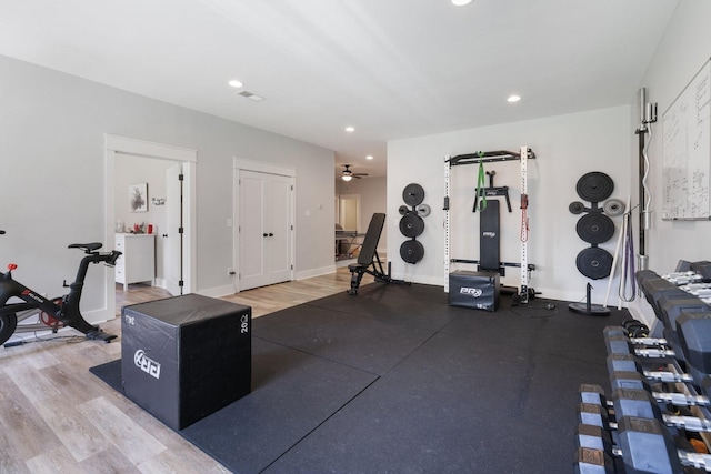 workout room featuring ceiling fan and hardwood / wood-style floors