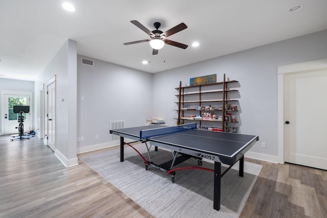 playroom with ceiling fan and light hardwood / wood-style floors