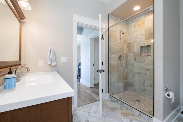 bathroom featuring walk in shower and vanity