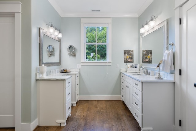 bathroom featuring wood-type flooring, vanity, and ornamental molding