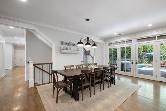 dining room with french doors, hardwood / wood-style floors, and crown molding