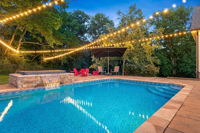 view of swimming pool featuring a hot tub, pool water feature, and a patio