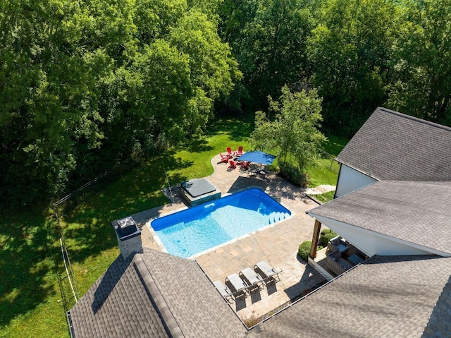 view of pool featuring a lawn and a patio area