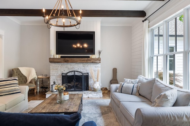 living room featuring beam ceiling, hardwood / wood-style floors, a chandelier, and a fireplace