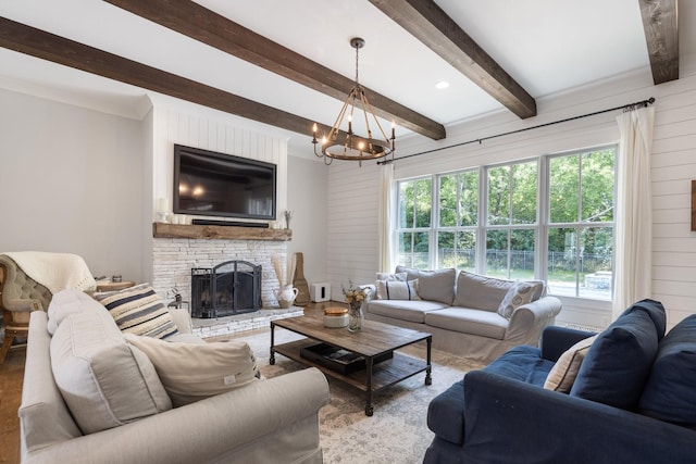 living room featuring wooden walls, a chandelier, beamed ceiling, and a stone fireplace