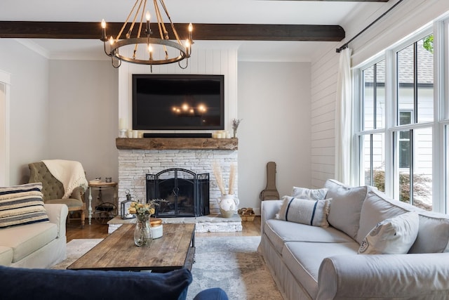 living room featuring wood-type flooring, a fireplace, a notable chandelier, and beamed ceiling